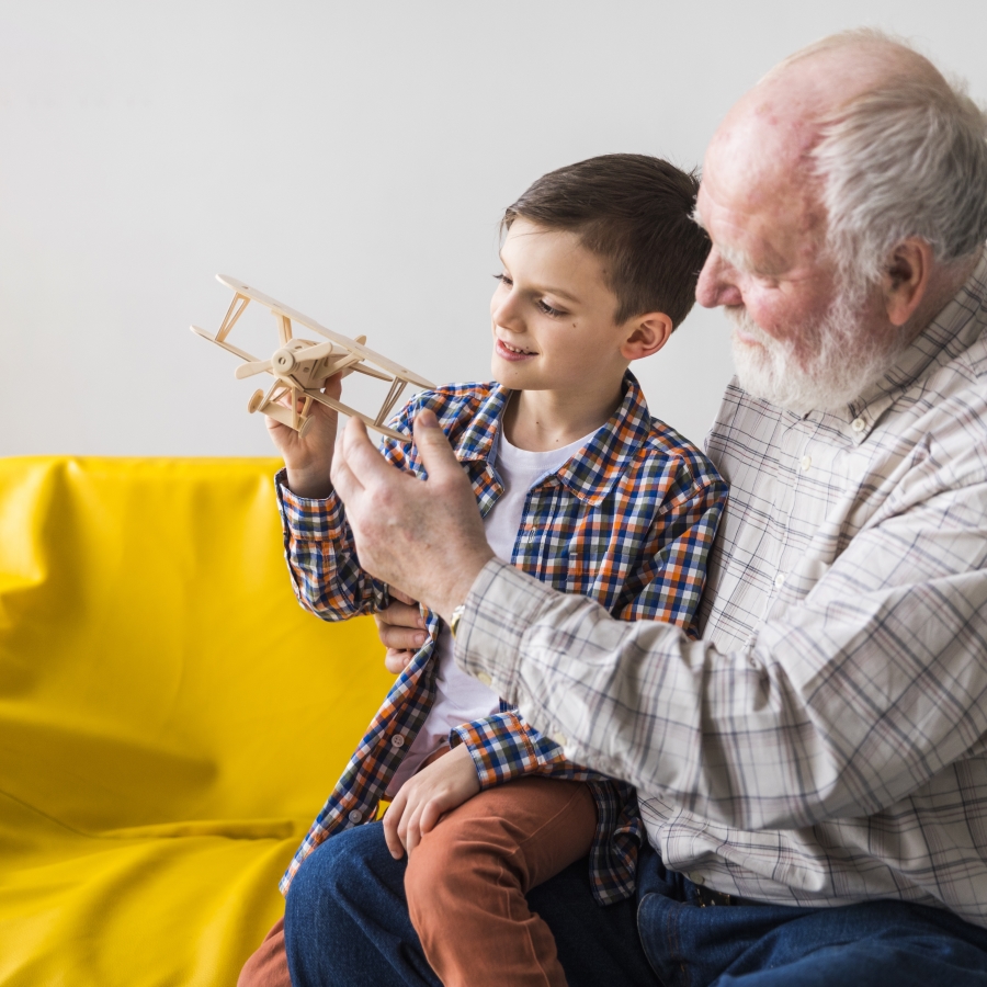 grandfather-and-grandson-playing-toy-plane