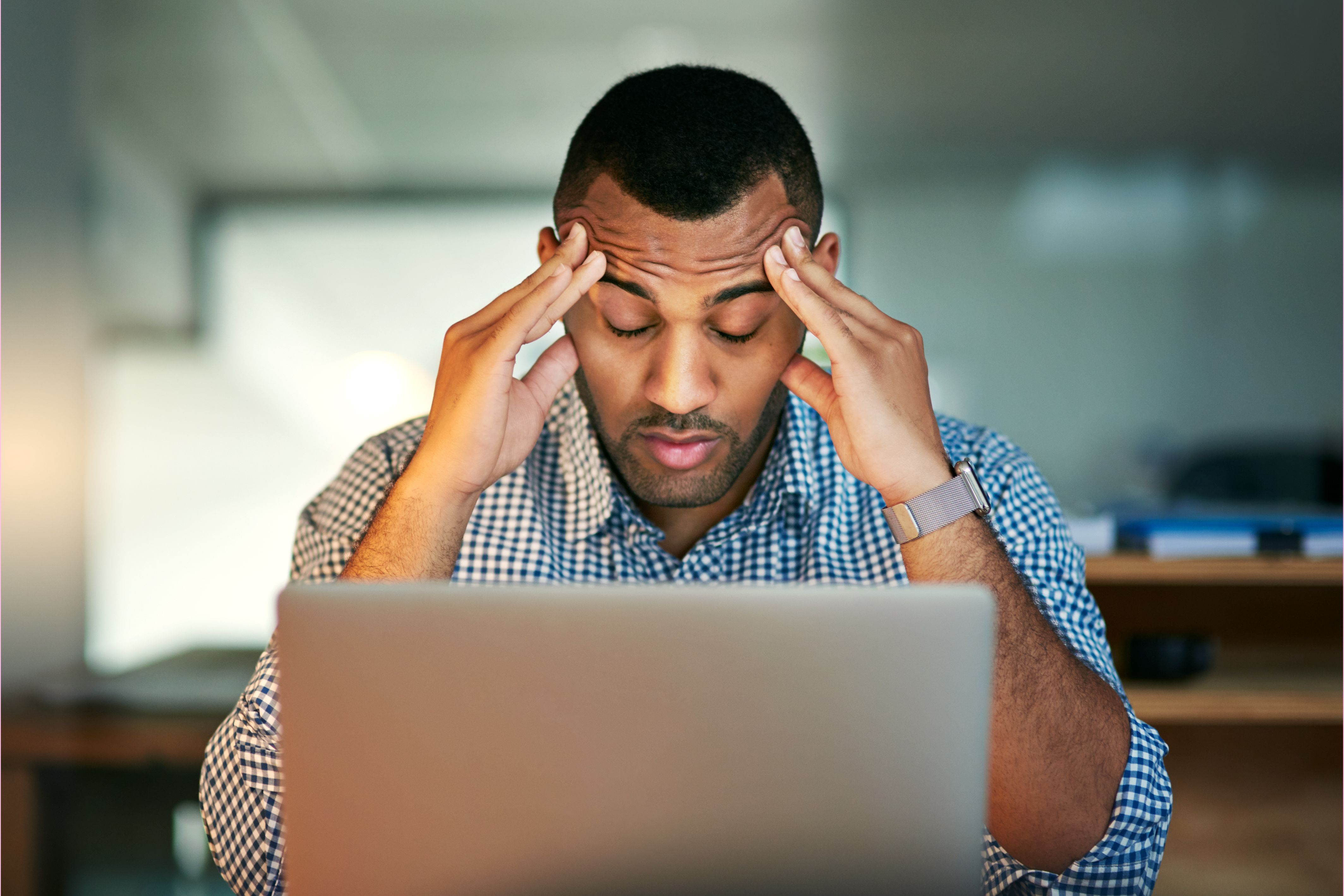 man stressed at laptop